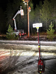 Electric Utility Lineman doing pole work while safely lit by an all-terrain LENTRY Light