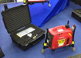Portable Lentry light system model 1SPECS-C23 shown on display at a tradeshow. The 1000 watt generator and fully retracted all-terrain legs and telescoping pole are facing right while the V-Spec LED light head is secured in Case C2318 to the side.