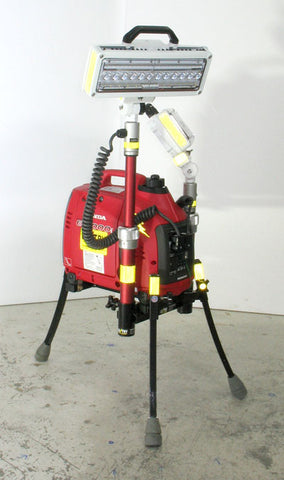 Dual LED LENTRY portable light system model 1SPECSS with a 1000 watt generator and two standard height V-Spec LED lights. The three independently adjustable legs are fully extended while one telescoping pole is fully extended with the light head aimed down and the other telescoping pole is fully retracted with the light head aimed up.