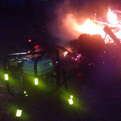 Night photo of Ventry Brush Fan accelerating the burning of a brush/debris pile
