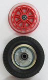 Both the Small Solid Rubber Wheel and the Medium Flat-Free Wheel are laying on a table next to each other for size comparison.