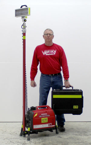 Even when fully retracted, Lentry LED Lighting System Model 2SPECH-C23 stands taller than the 6-foot man standing next to the system. A Case in included to store the LED light head.