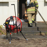 24-inch VENTRY Fan Model 24GX200 with optional upgraded Medium Flat-Free Wheels and Skids shown during a fire department's PPV training. The three independently adjustable legs are extended at different lengths, allowing the air to be raised above the stairs and into the front door. The fan is also set off to the side, allowing clear access fo the firefighter entering the house carrying a hose.